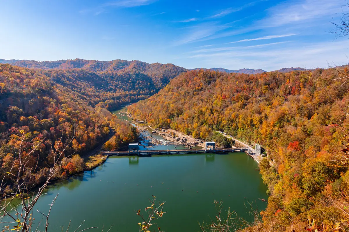 an image of a lake with trees surrounding it in the mountains in Tennesse